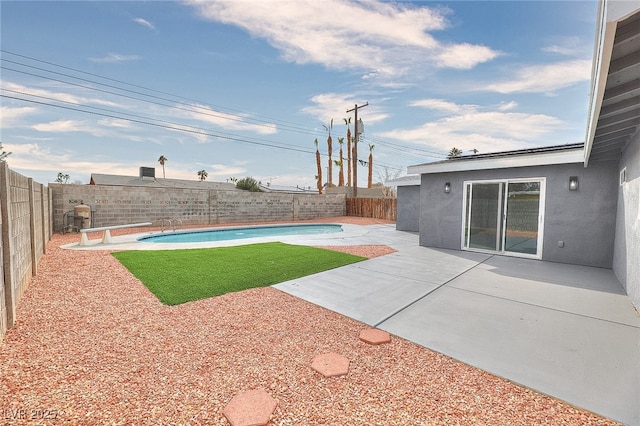 view of swimming pool featuring a fenced backyard, a fenced in pool, and a patio