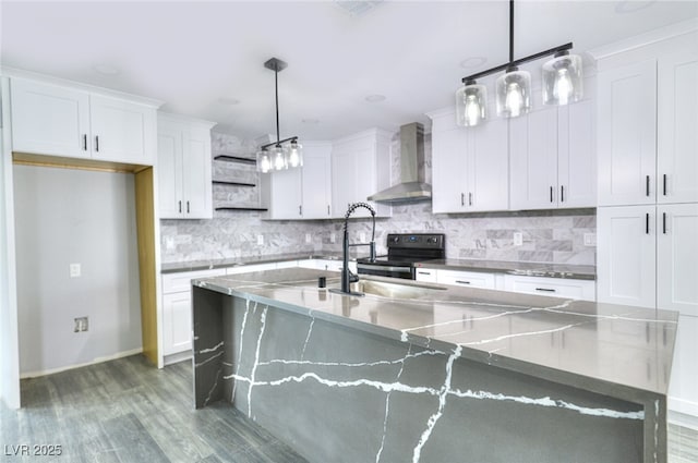 kitchen with decorative backsplash, wall chimney exhaust hood, wood finished floors, white cabinetry, and a sink