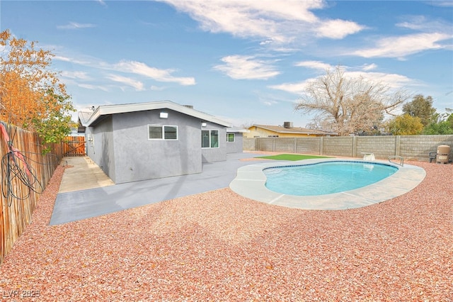 view of swimming pool with a patio, a fenced backyard, and a fenced in pool