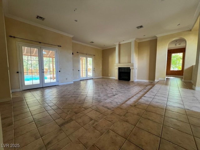 unfurnished living room featuring french doors, plenty of natural light, and light tile patterned floors