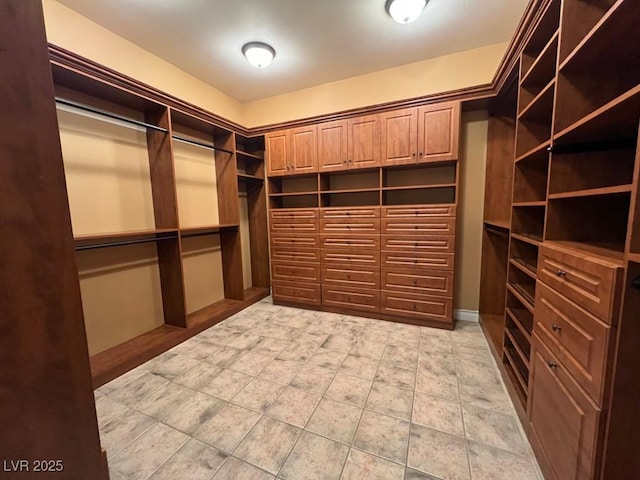 walk in closet with light tile patterned flooring