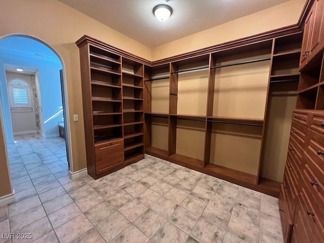 spacious closet featuring light tile patterned floors