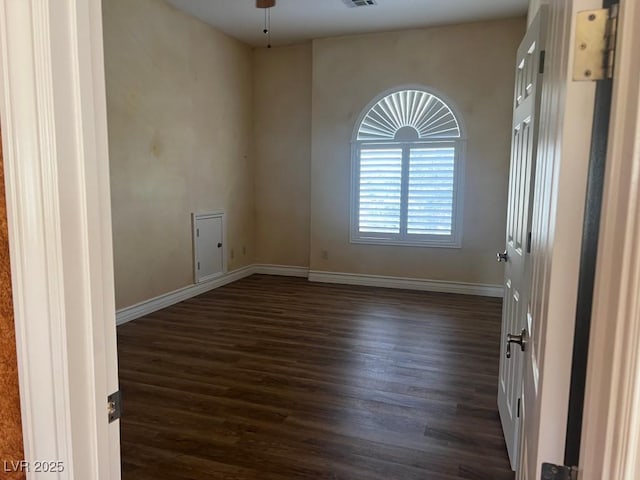 spare room featuring ceiling fan and dark hardwood / wood-style floors