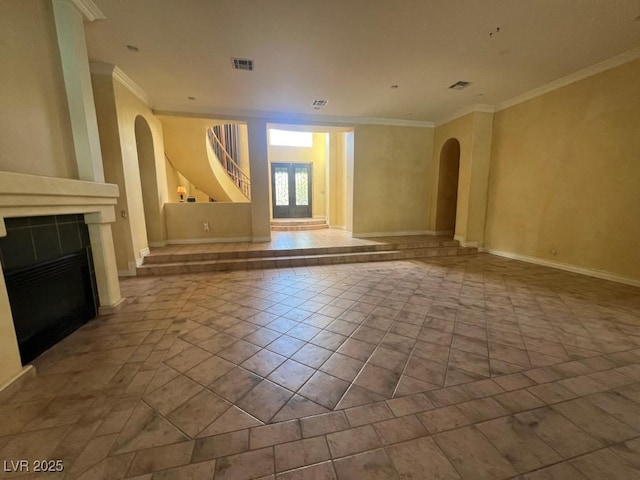 unfurnished living room featuring crown molding, light tile patterned floors, and a fireplace