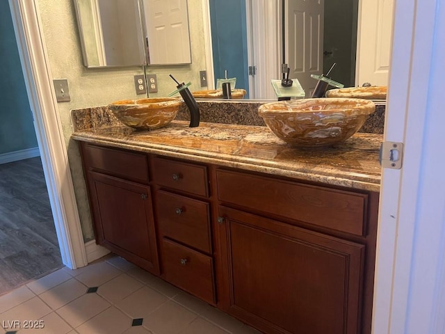 bathroom featuring tile patterned flooring and vanity