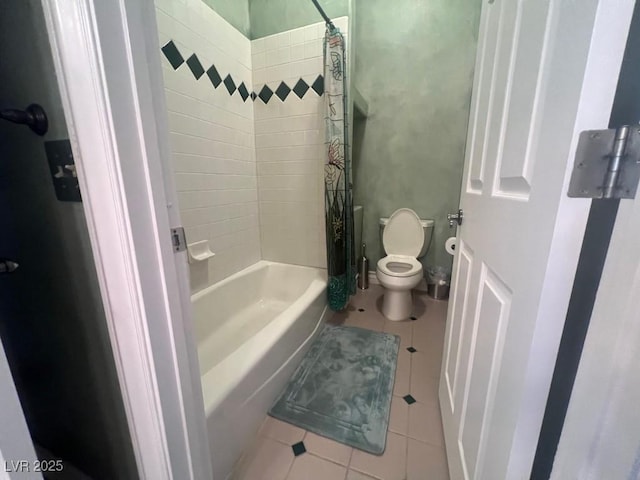 bathroom featuring tile patterned flooring, shower / tub combo, and toilet