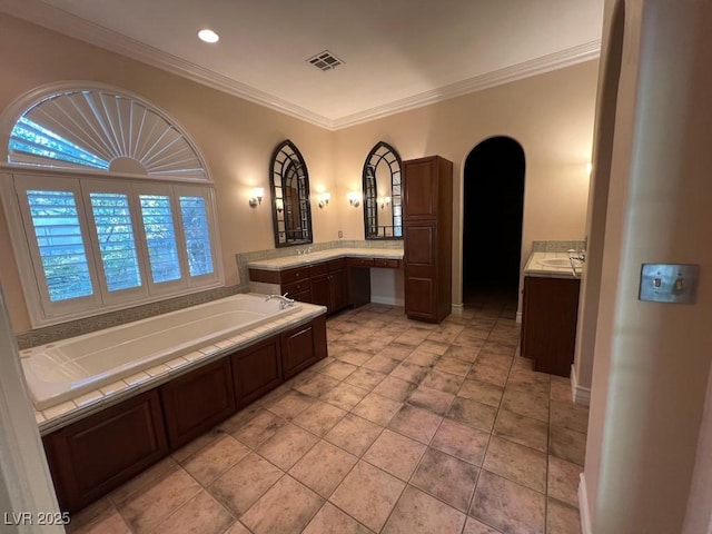 bathroom with ornamental molding, vanity, a bathtub, and tile patterned floors