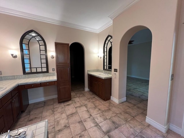 bathroom featuring crown molding, tile patterned floors, and vanity