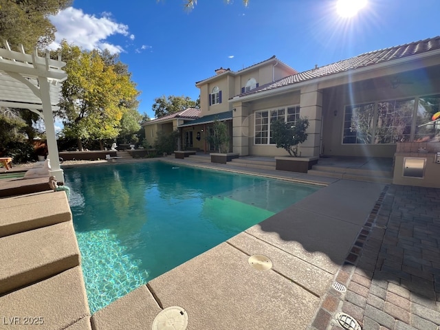 view of swimming pool with a pergola and a patio