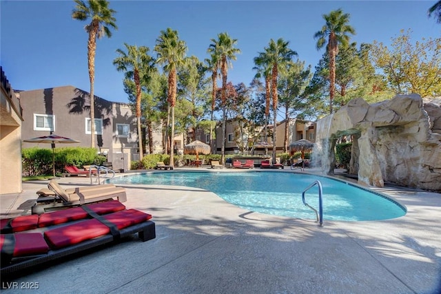 view of pool featuring pool water feature and a patio area