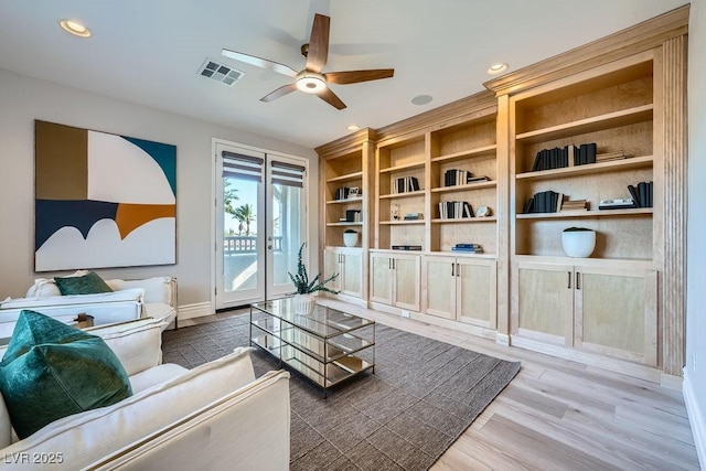 living room with hardwood / wood-style floors and ceiling fan