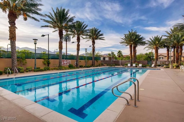 view of swimming pool with a mountain view and a patio area