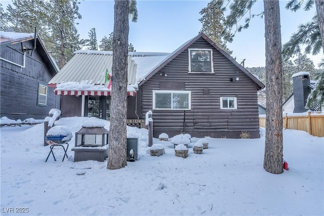 view of snow covered rear of property