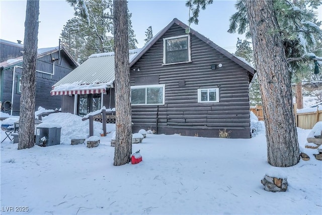 view of snow covered rear of property