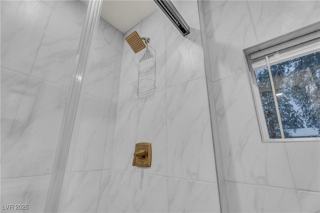 interior details with a tile shower