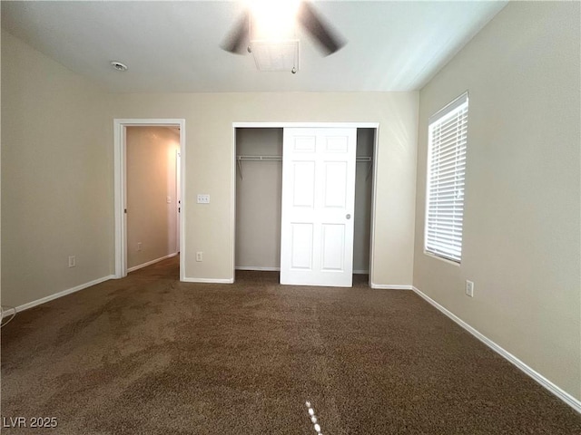 unfurnished bedroom with a closet, carpet, a ceiling fan, and baseboards