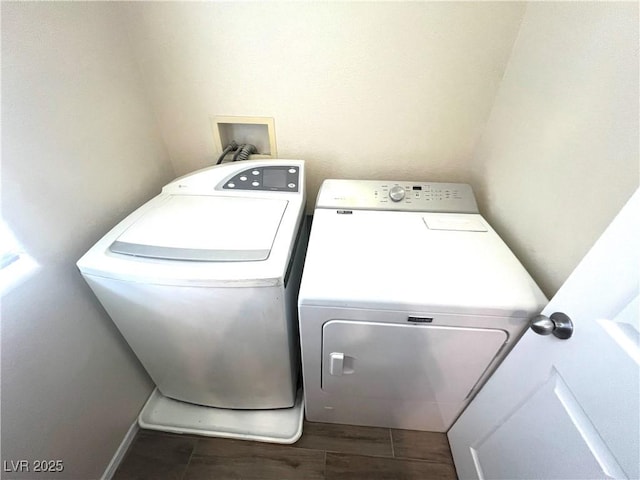 clothes washing area featuring washer and dryer, laundry area, and wood tiled floor