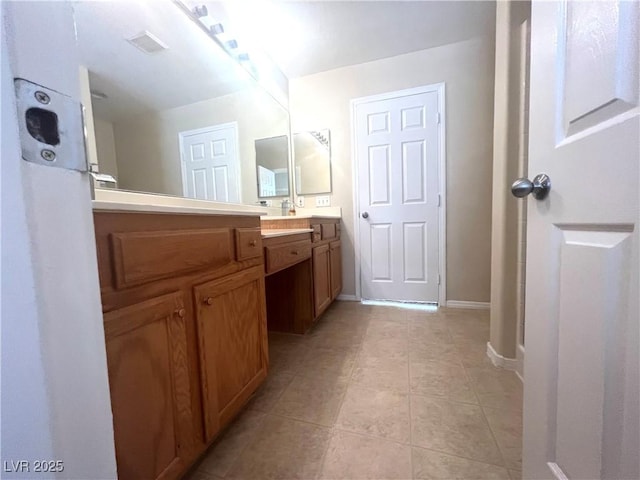 full bathroom featuring tile patterned floors, vanity, and baseboards