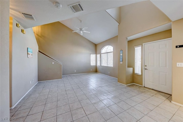 tiled entrance foyer with high vaulted ceiling and ceiling fan