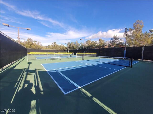 view of tennis court featuring fence