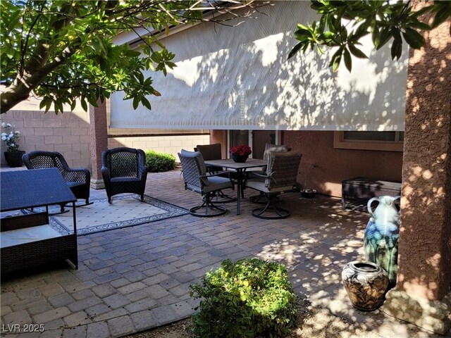 view of patio / terrace featuring outdoor dining area and fence