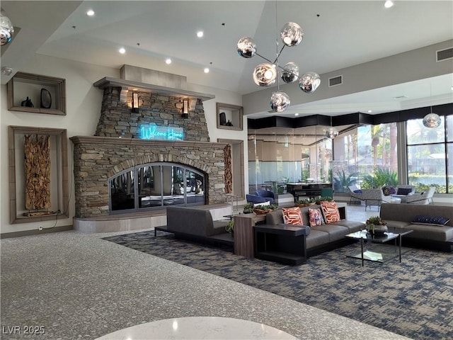 living area with high vaulted ceiling, a stone fireplace, visible vents, and recessed lighting