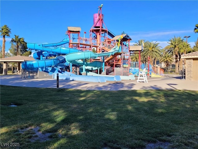 community jungle gym featuring a yard