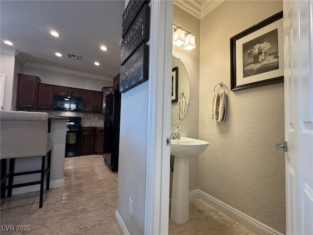 bathroom featuring visible vents, baseboards, decorative backsplash, a textured wall, and crown molding