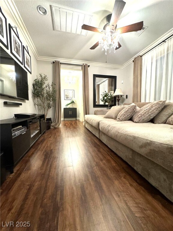 bedroom featuring dark wood-style floors, a ceiling fan, and crown molding