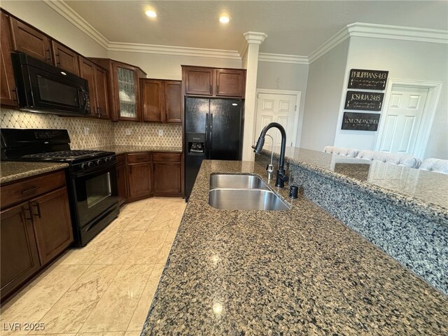 kitchen featuring a sink, dark stone counters, black appliances, tasteful backsplash, and crown molding