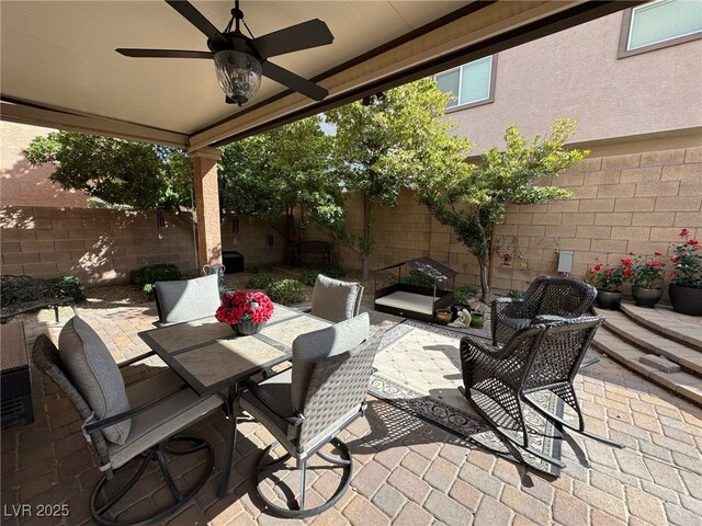 view of patio / terrace with a ceiling fan, outdoor dining area, and a fenced backyard