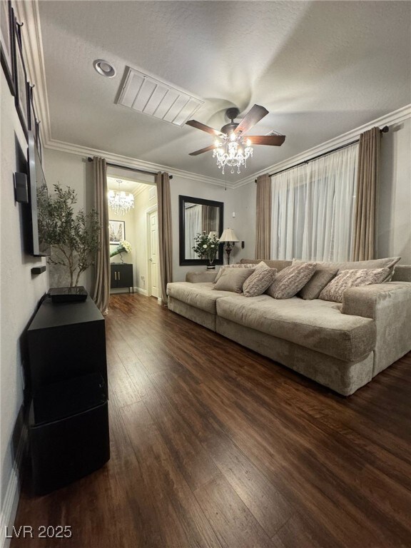 living room featuring a ceiling fan, dark wood-style flooring, crown molding, and baseboards