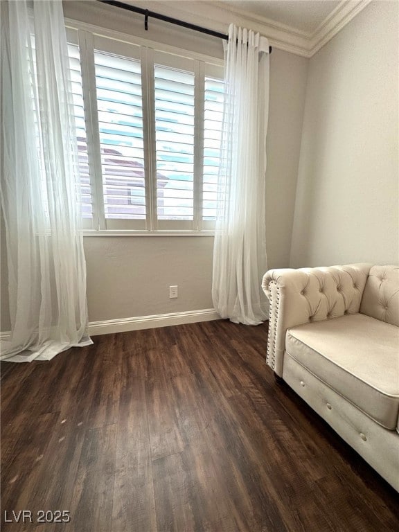 bedroom with ornamental molding, dark wood-style flooring, and baseboards