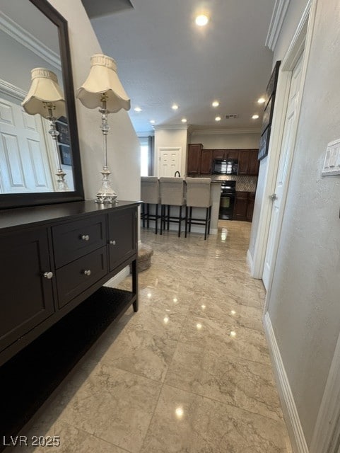 hallway with recessed lighting, visible vents, crown molding, and baseboards