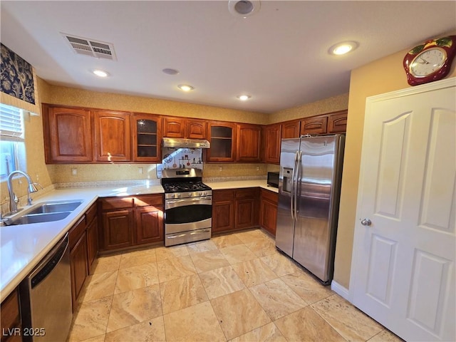 kitchen with tasteful backsplash, appliances with stainless steel finishes, and sink