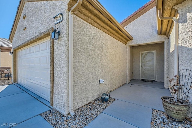 doorway to property with a garage