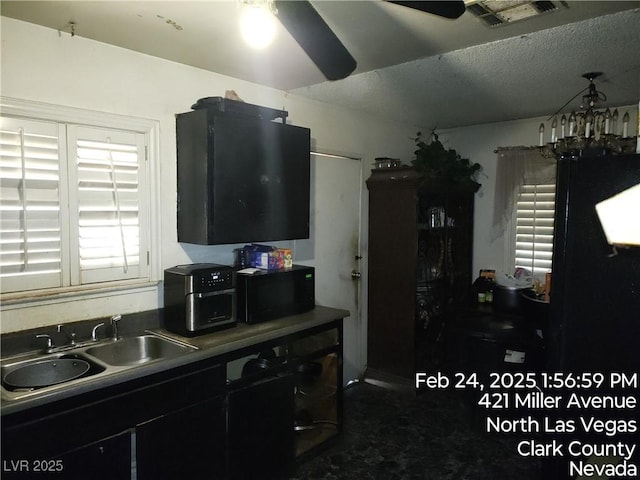 421 Miller Ave, North Las Vegas, NV 89030 - kitchen featuring a sink, a textured ceiling, visible vents, a ceiling fan, and black microwave