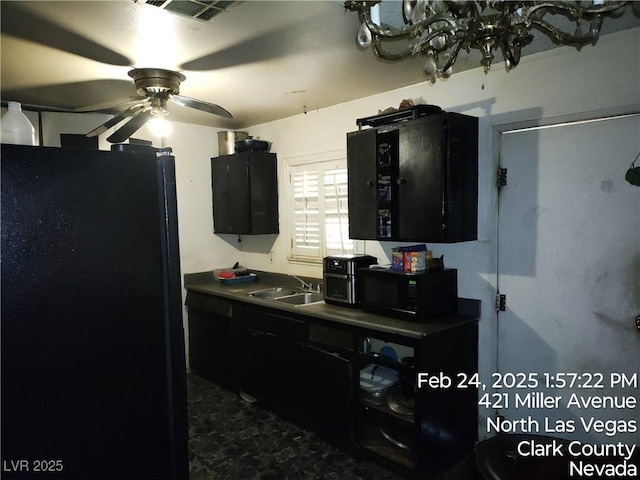 421 Miller Ave, North Las Vegas, NV 89030 - kitchen with dark cabinetry, a sink, black appliances, and ceiling fan with notable chandelier