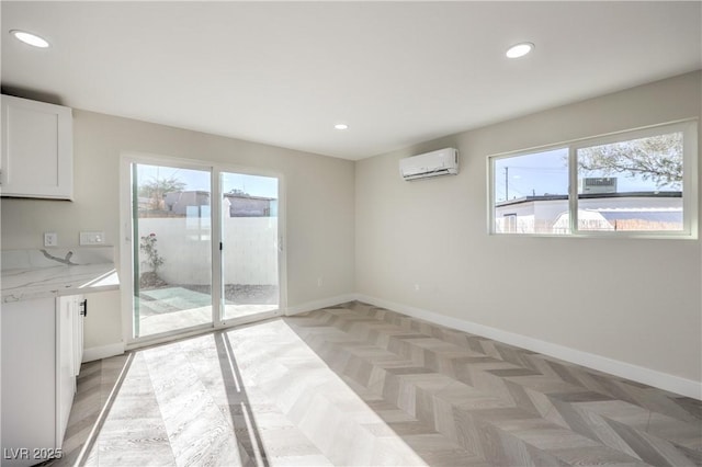 interior space featuring a wall unit AC and light parquet floors