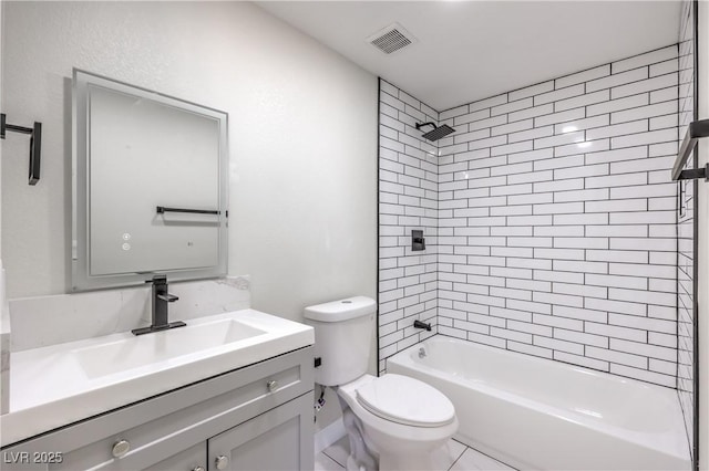 full bathroom with tiled shower / bath, vanity, and toilet