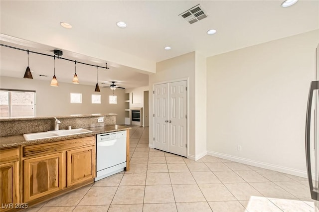 kitchen featuring visible vents, white dishwasher, light tile patterned flooring, a sink, and recessed lighting