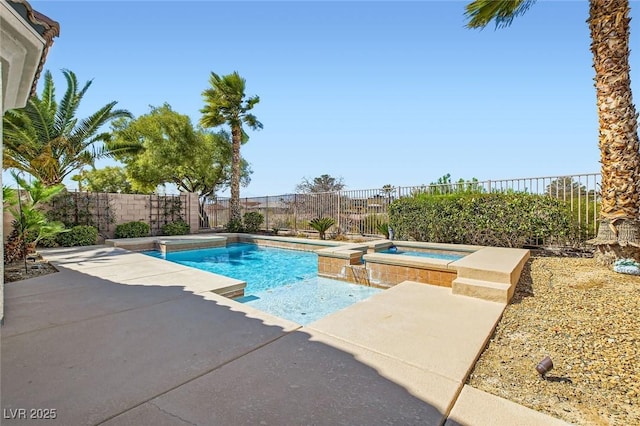 view of pool featuring a patio area, a fenced backyard, and a pool with connected hot tub