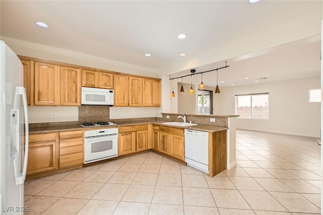 kitchen with light tile patterned flooring, recessed lighting, a peninsula, white appliances, and a sink