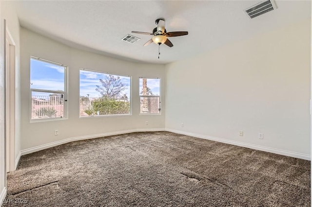 empty room with carpet, visible vents, ceiling fan, and baseboards