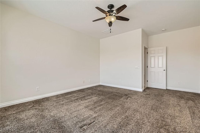 carpeted spare room featuring a ceiling fan and baseboards