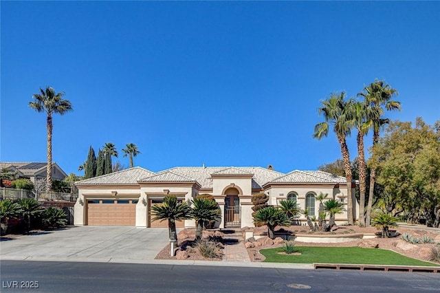 mediterranean / spanish home with a garage