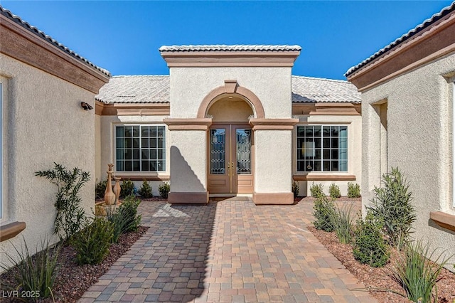 view of exterior entry featuring a patio area