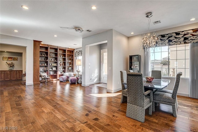 dining room featuring hardwood / wood-style floors and a chandelier