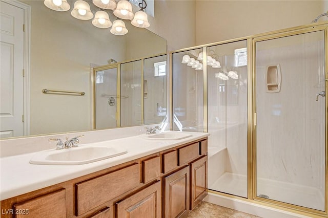 bathroom featuring a shower with door, vanity, and tile patterned floors