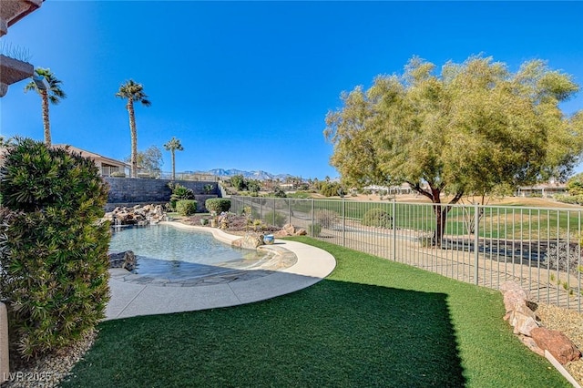 view of pool with a mountain view and a yard